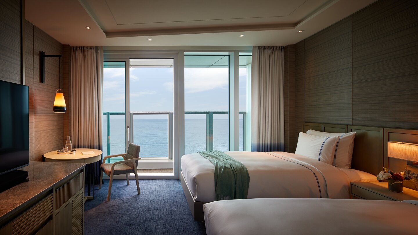 Grand Deluxe 客房的床鋪與海景陽台